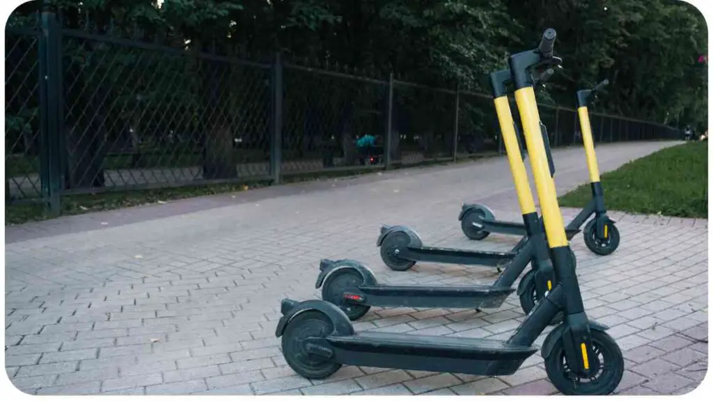 three electric scooters are lined up on the sidewalk